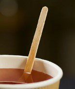 Wooden stir stick in cup of tea